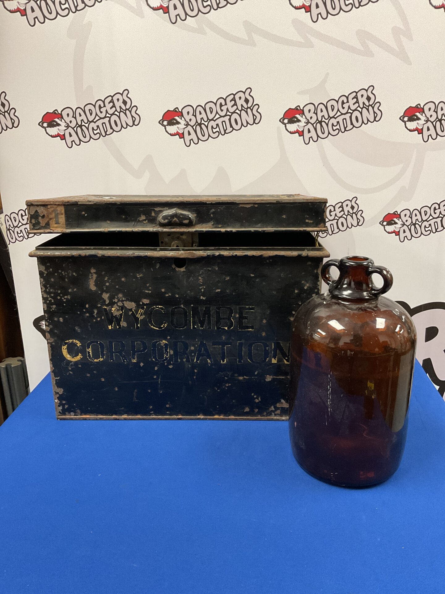 024 Antique Wycombe Corporation tin chest and brown glass demijohn