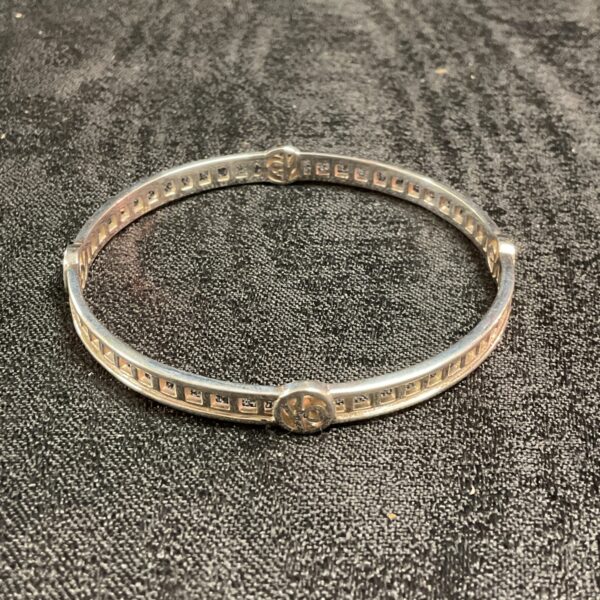 Close-up of a 925 silver Celtic bracelet with intricate knotwork.