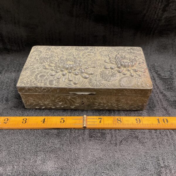 Antique Chinese cigarette box with lotus decoration, detailed whitemetal work.