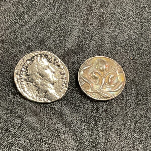 Antique silver buttons featuring Art Nouveau and coin designs.
