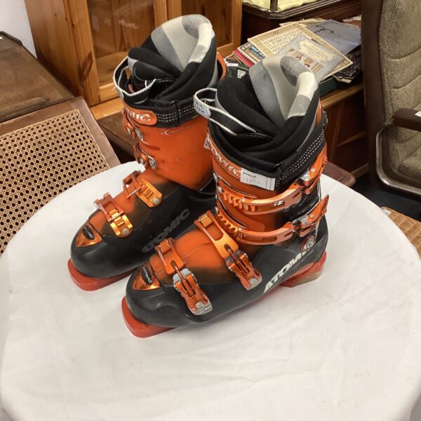 Orange and black Atomic ski boots for alpine skiing.