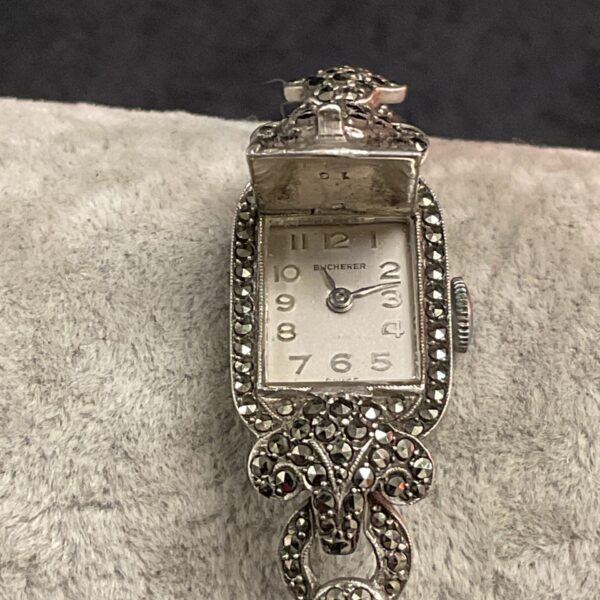 Close-up of vintage Bucherer marcasite ladies watch with silver tone case.