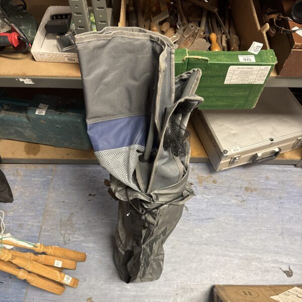 Portable camping chair with cupholders, folded for storage.