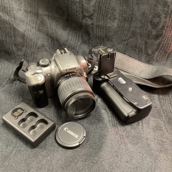 Canon EOS 300D digital SLR camera with lens and battery grip.
