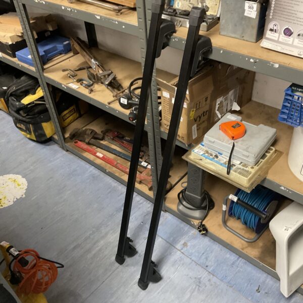 Used car roof bars with locking keys for vehicle transport.