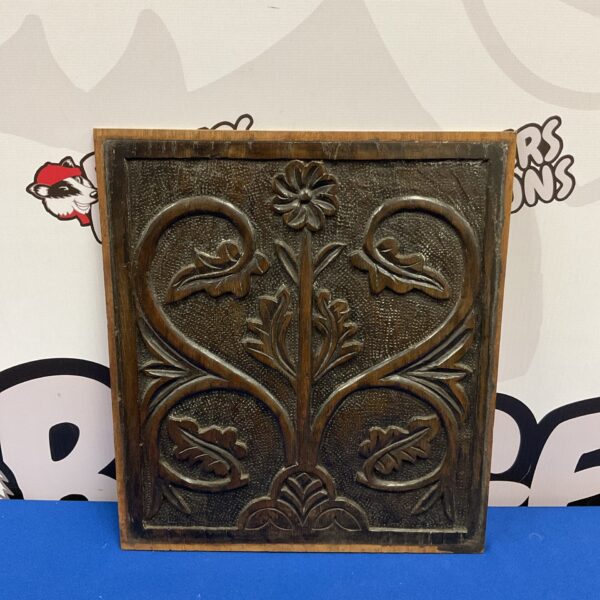 Vintage carved oak panel with a detailed floral motif.