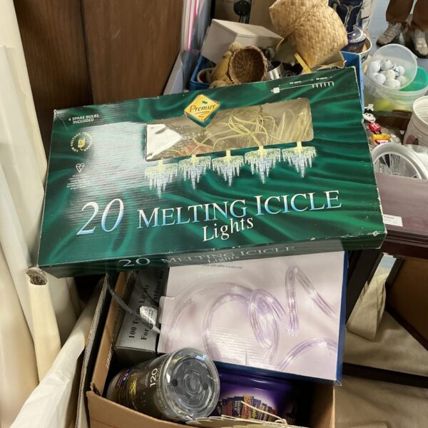 Box of vintage Christmas icicle lights with spare bulbs.
