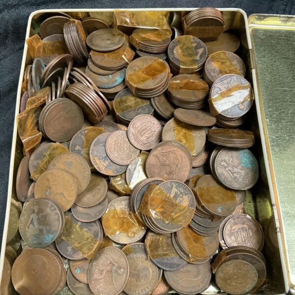 Large tin filled with vintage copper pennies for collectors.