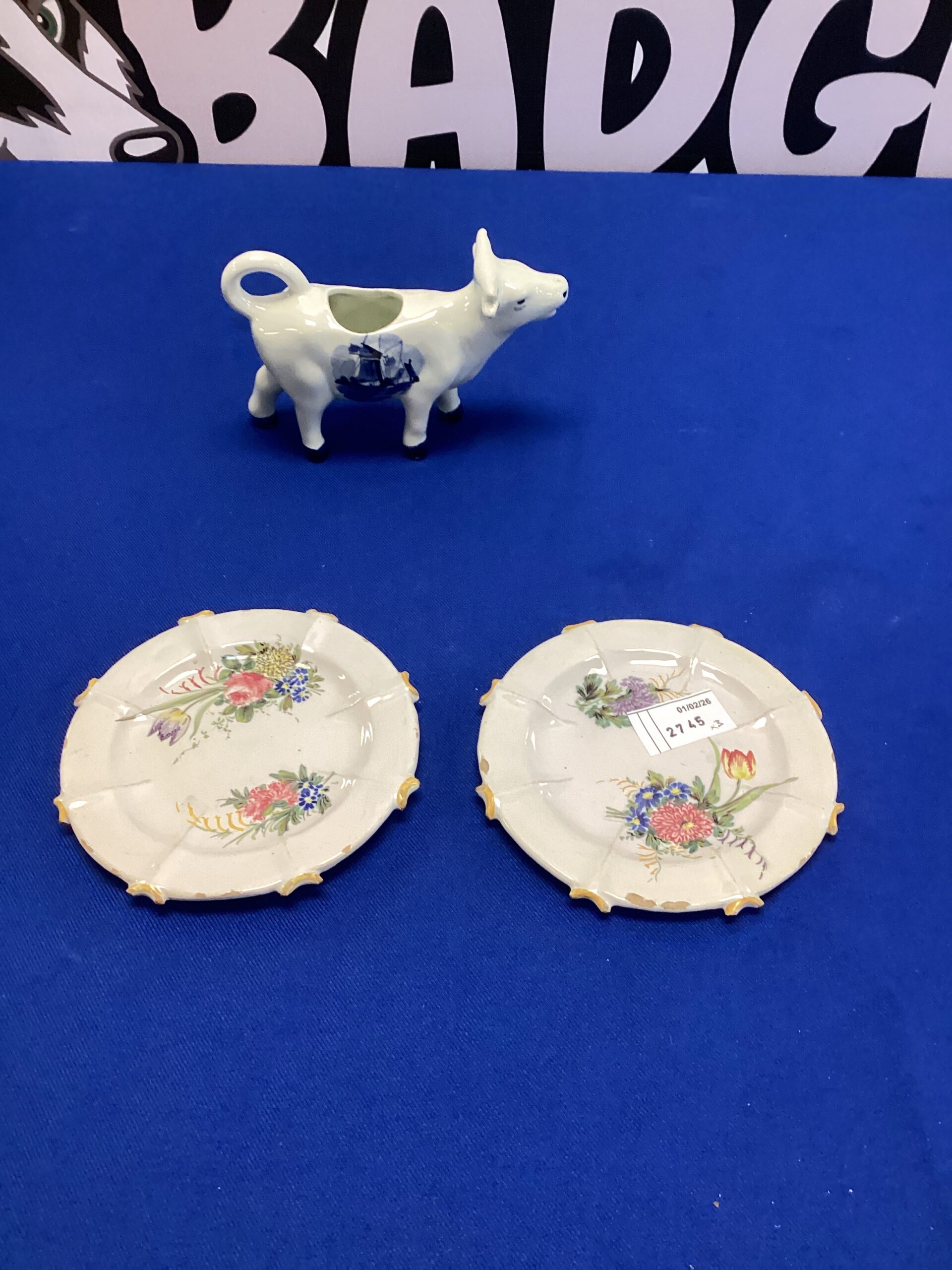 234 Two vintage china saucers with delft cow milk/cream jug