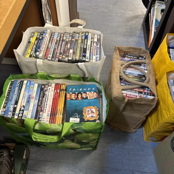 Stack of DVDs within a carrier bag, a DVD job lot.