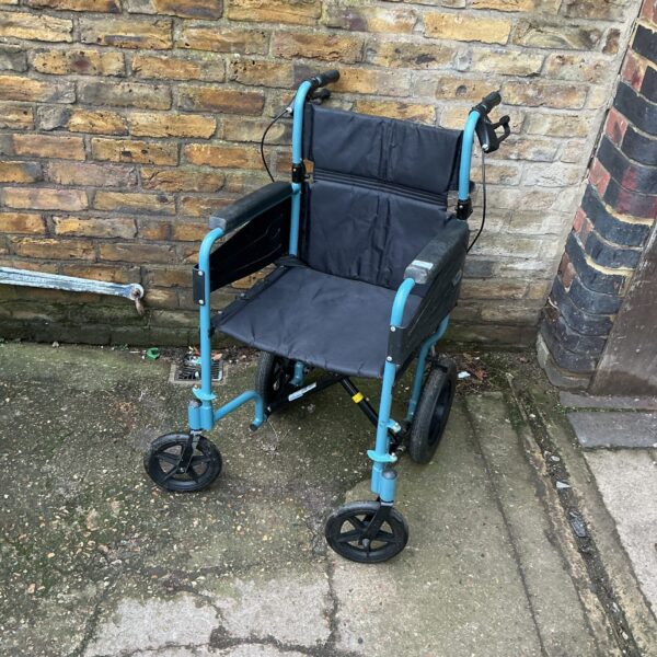 Blue folding wheelchair, a portable mobility aid.