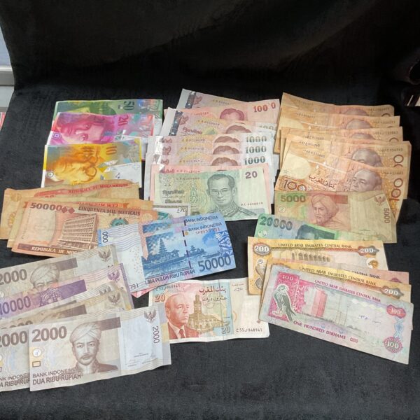 Diverse collection of foreign banknotes and world currency notes.