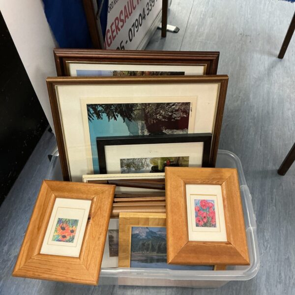 Mixed lot of framed artwork and vintage photographs for wall decor.