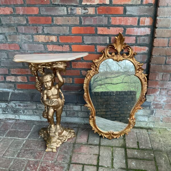 Gilded cherub pedestal hall table with ornate French style mirror.