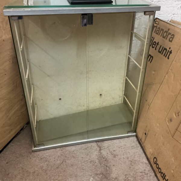 Front view of a glass display cabinet with clear shelves.