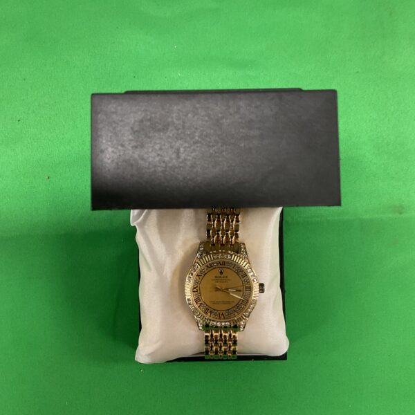 Gold-tone fashion quartz wristwatch with bold bracelet strap.