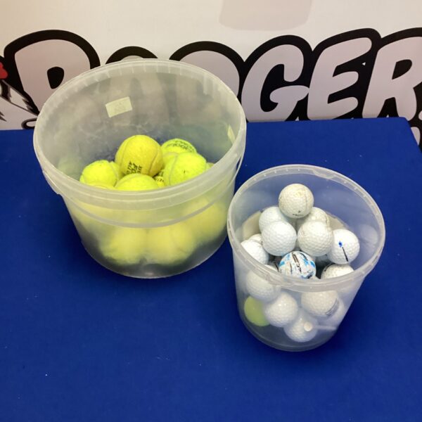 Mixed lot of used golf and tennis balls for sports practice.