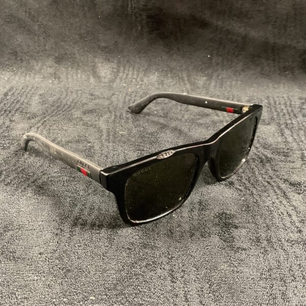 Black Gucci sunglasses with logo detail on the temple.