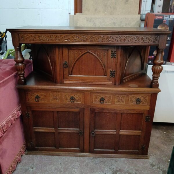 Vintage oak Jacobean court cabinet with carved details.