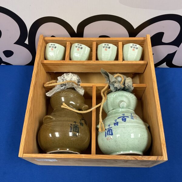 Vintage Japanese sake set with ceramic bottle and wooden box.
