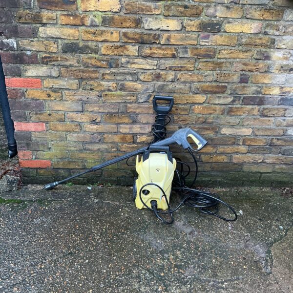 Yellow Karcher power washer for garden and patio cleaning.