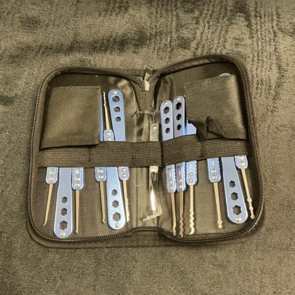 Close-up of a lock pick set with various tools inside a pouch.