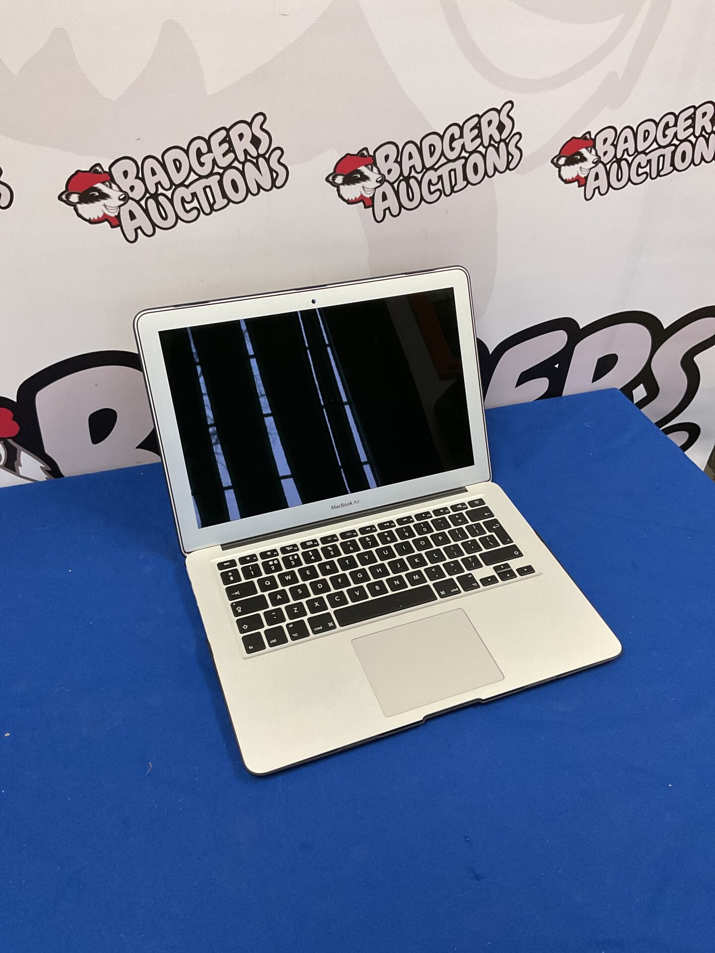 165 Apple Macbook Air model 1466 with blue protective shell powers on but pin locked