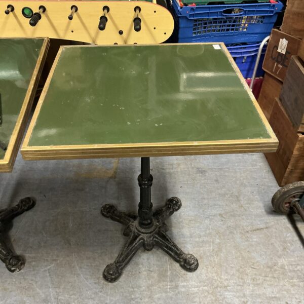 Vintage metal based table with cast iron base.