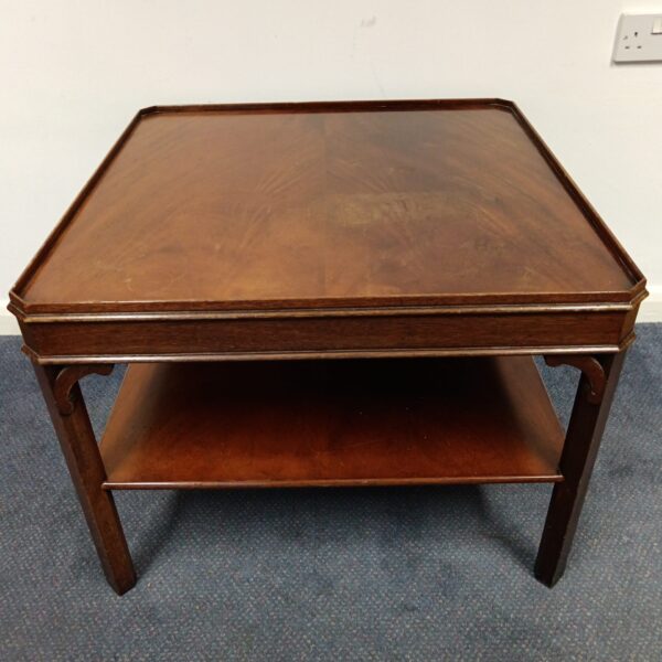Square mid-century coffee table with warm wood finish.