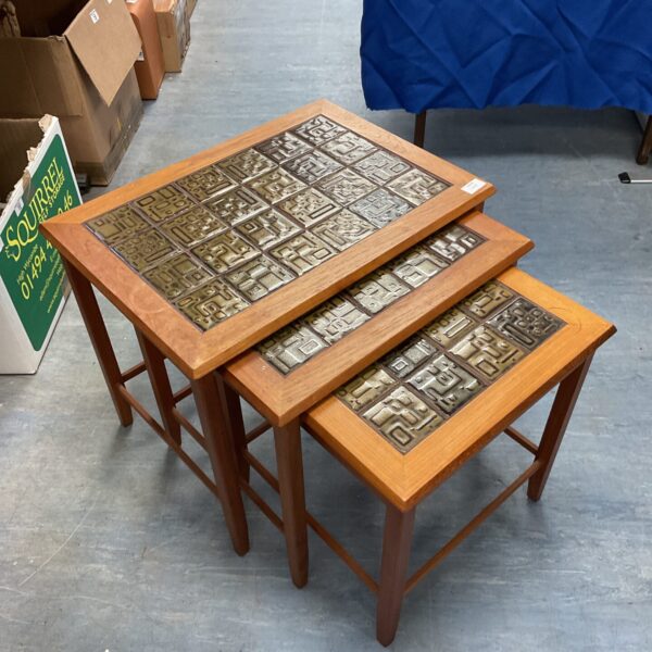 Vintage mid-century nest of tables with geometric tile tops.