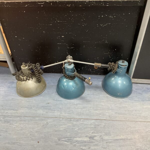 Set of three vintage military workshop lamps for portable lighting.