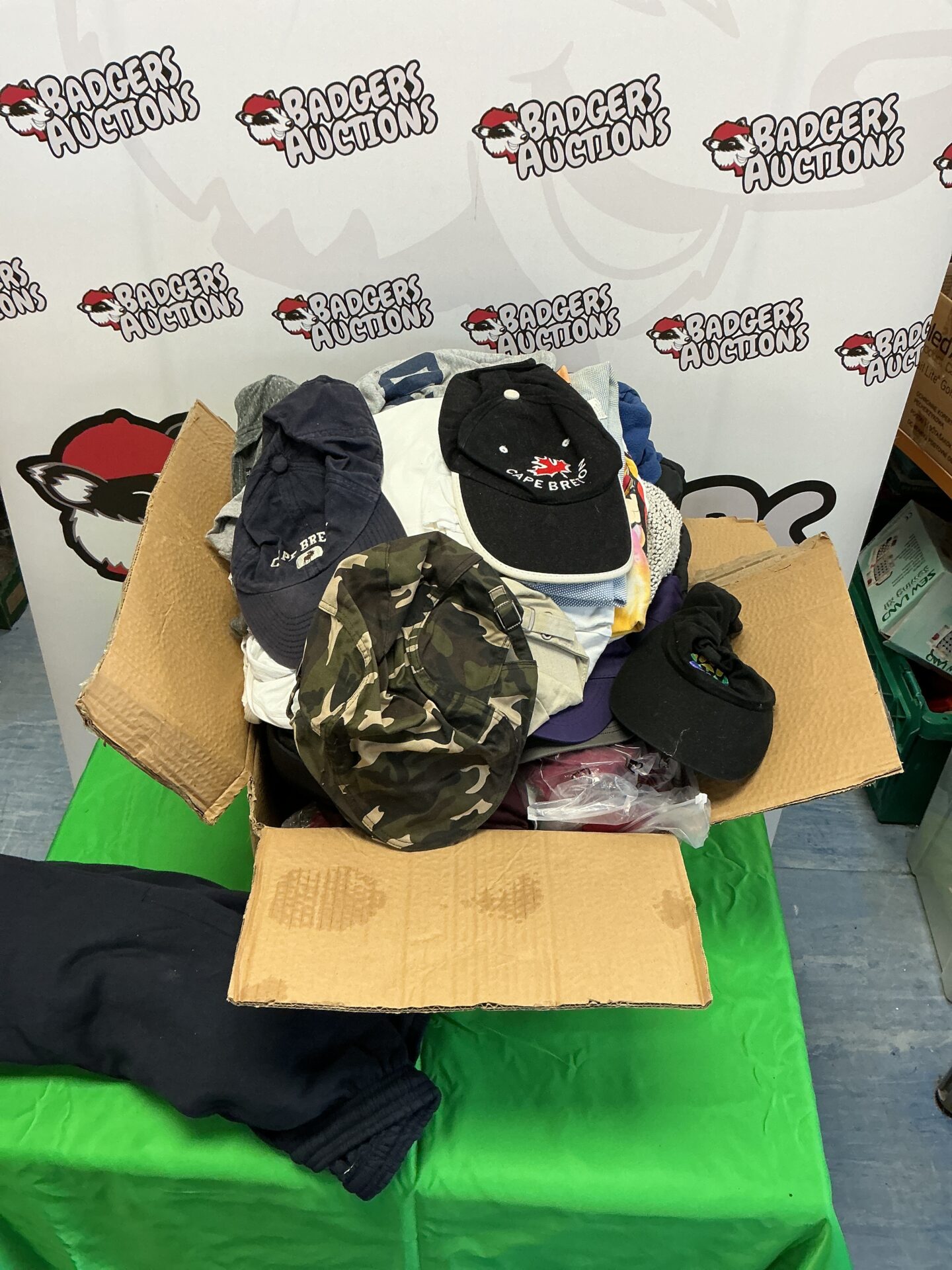 586 Box of mixed clothing and caps
