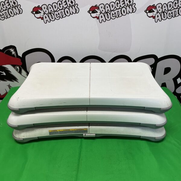 Stack of three white Nintendo Wii Fit balance boards.