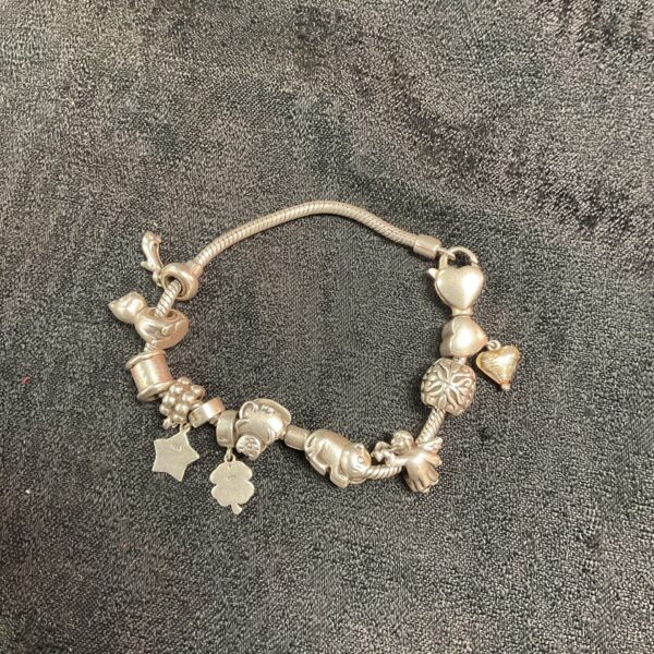 Vintage Pandora silver charm bracelet with eleven charms displayed.