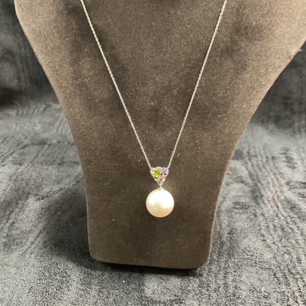 Pandora silver necklace with faux pearl pendant and white stone.
