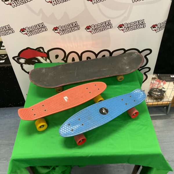 Collection of penny boards and skateboards for sale.