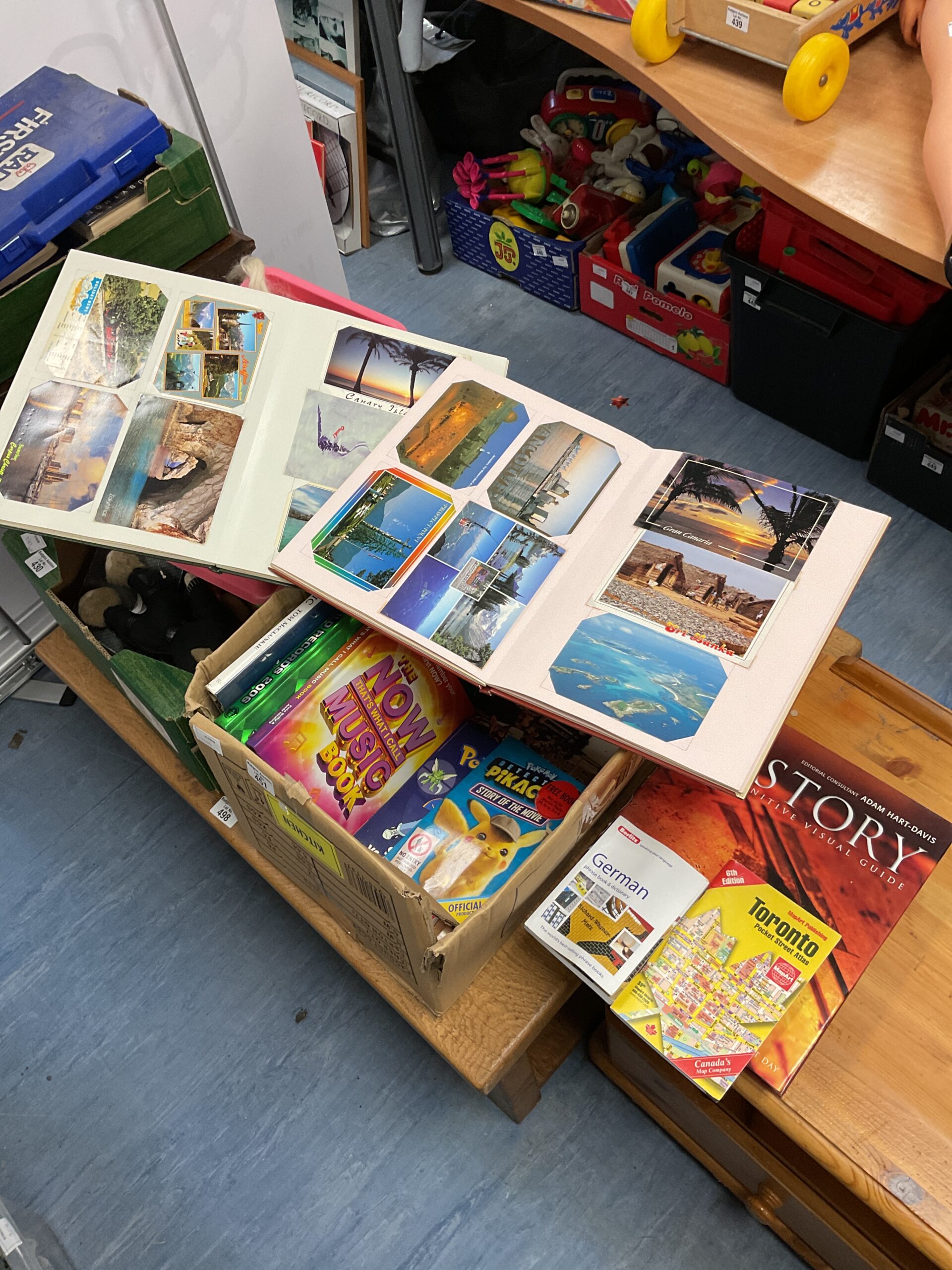 372 Box of books, including Pokémon and two Kew Gardens postcard albums