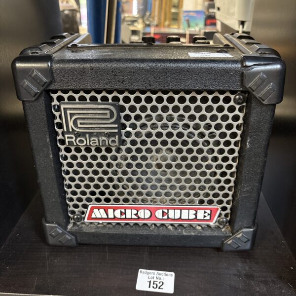 Black Roland Microcube guitar amplifier, side view.