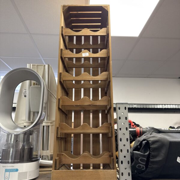 Rustic wooden wine rack holding twelve bottles.