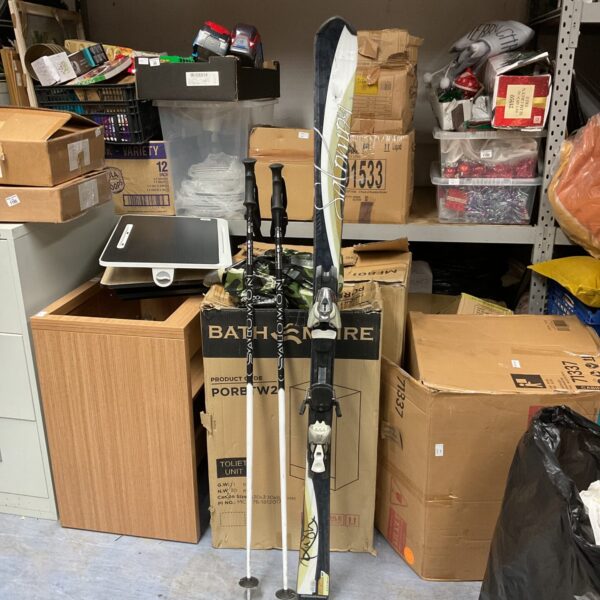 Salomon ski set with poles, vintage winter sports equipment.