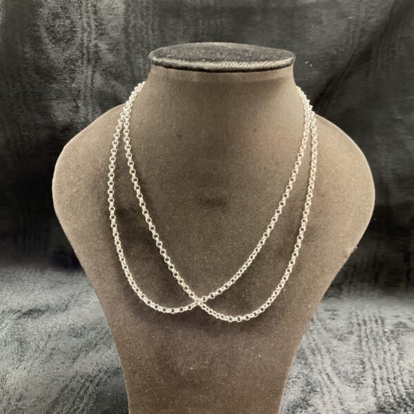 Pair of delicate 925 silver chain necklaces on display.