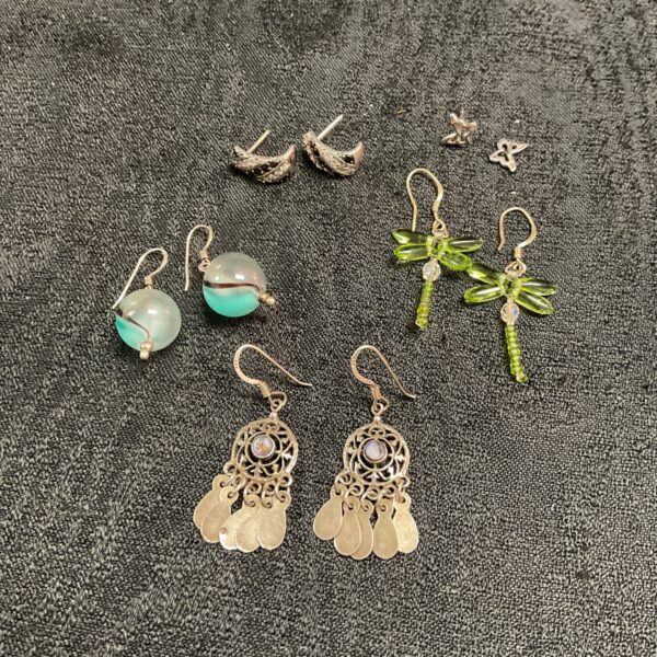 Silver earrings lot with various styles and designs.