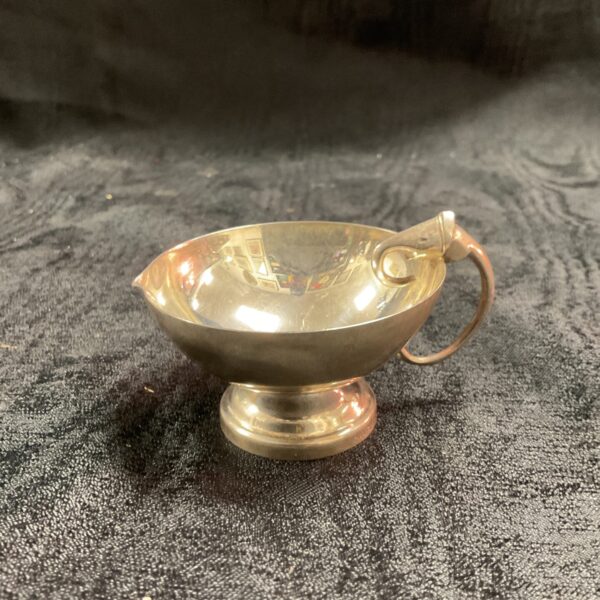 Antique silver jug with elephant handle, collectible silverware.