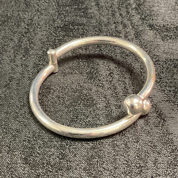 Silver hinged bracelet with decorative ball ends.