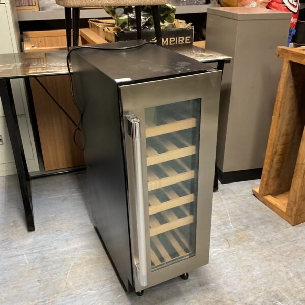 Stainless steel slimline wine chiller fridge on a countertop.
