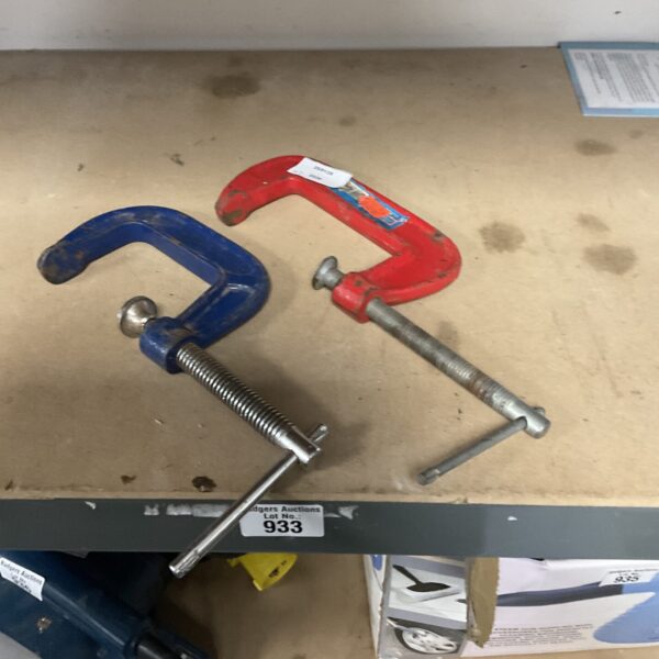 Pair of small metal G clamps for woodworking and DIY projects.