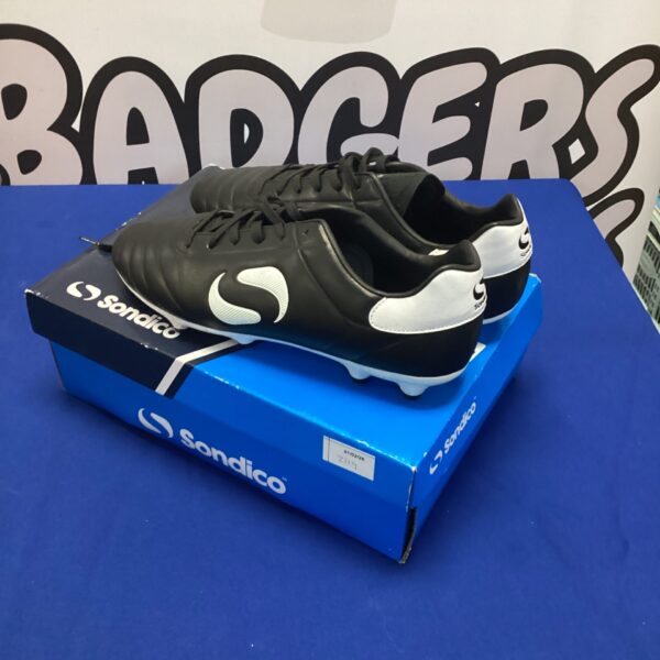 Size 9 Sondico astroturf football boots on a display stand.