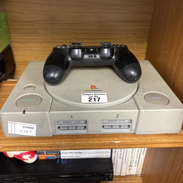 Sony PlayStation 1 console with PS4 controller for retro gaming.