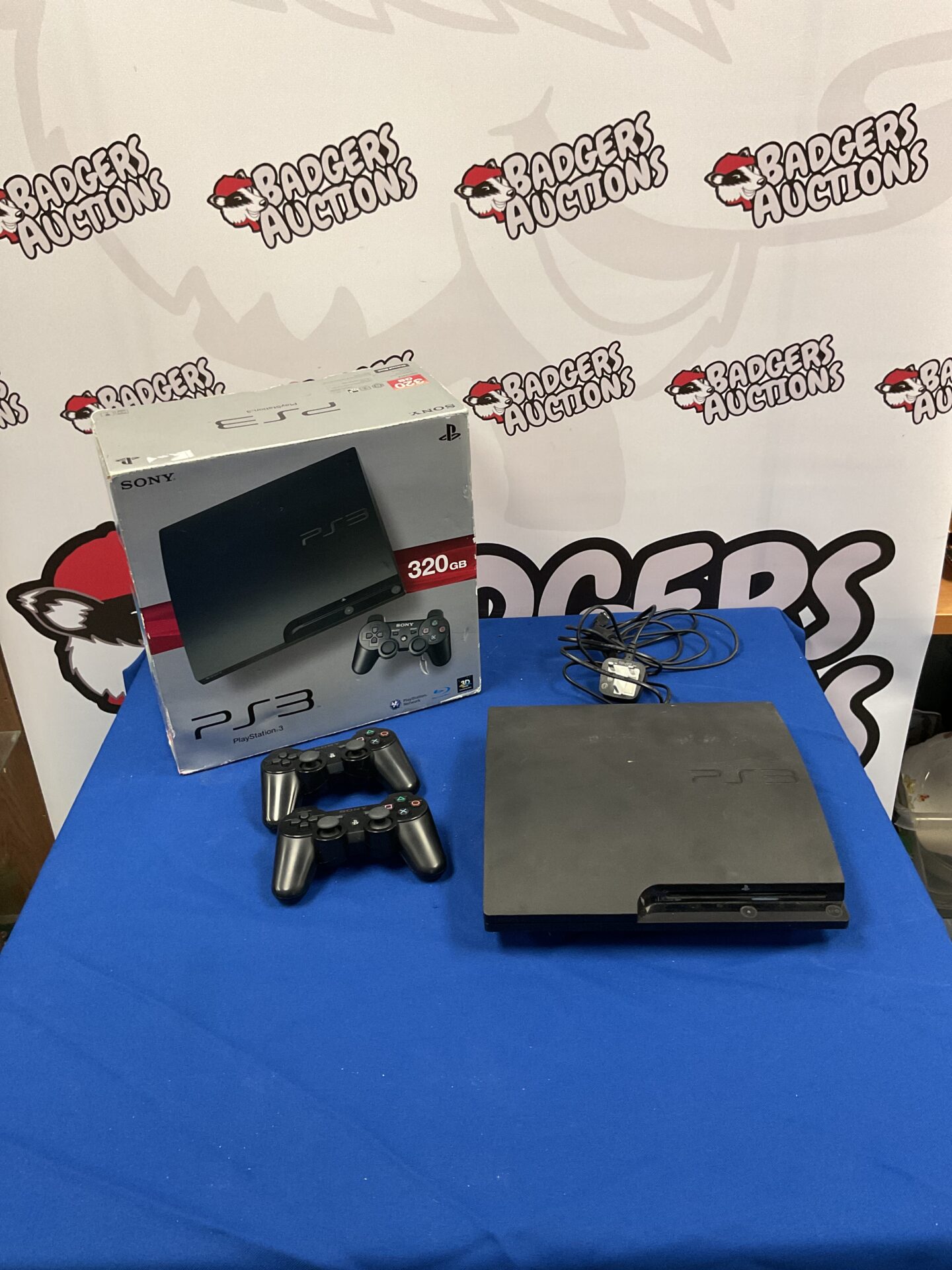 143 Sony Playstation 3 console with two remotes and power cord
