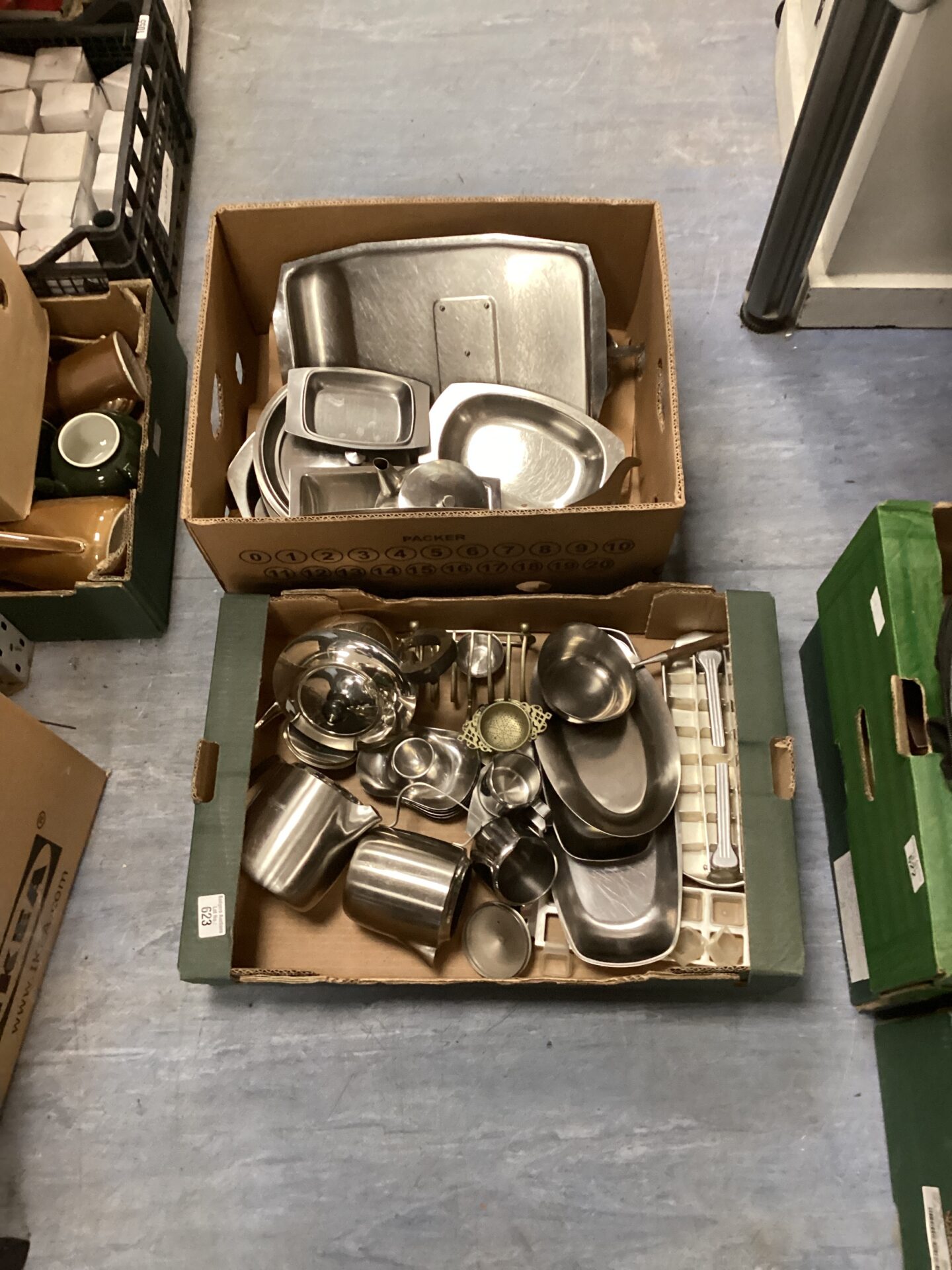 621 Two boxes of mixed stainless steel tableware, including teapots coffee pots and serving trays
